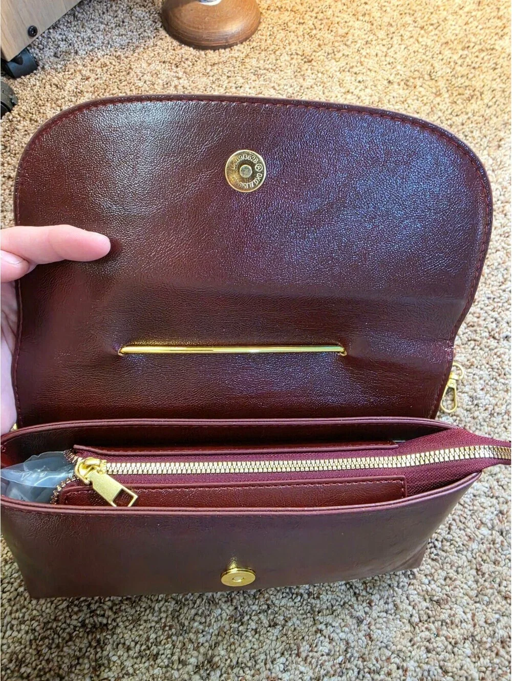Elegant Burgundy Faux Leather Clutch Bag with Gold Chain and Safety Pin Detail